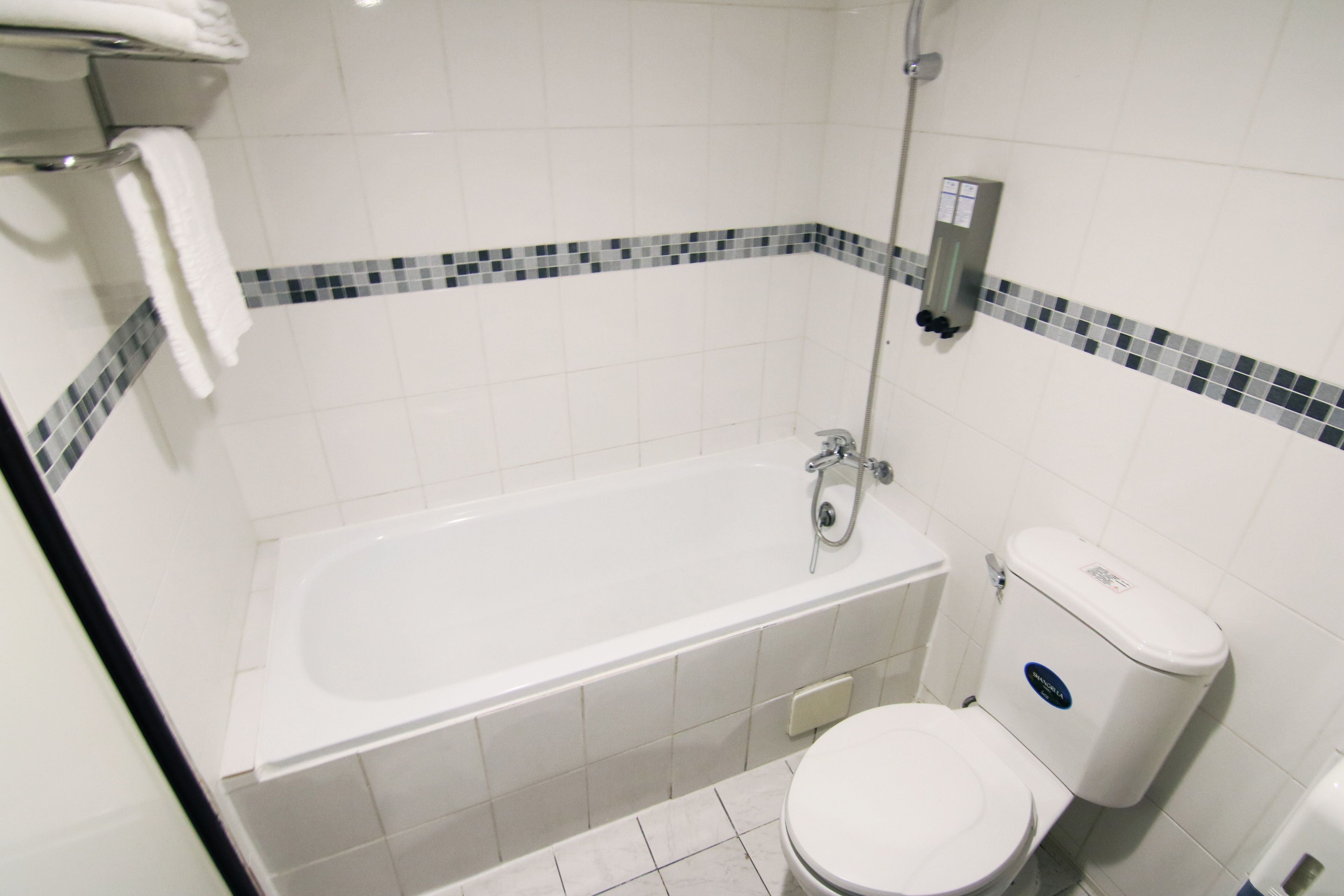 Un baño con bañera, inodoro y zona de ducha.