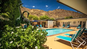 A pool area with lounge chairs and a view of a mountain. - Old Ranch Inn - Adults Only  (Palm Springs)