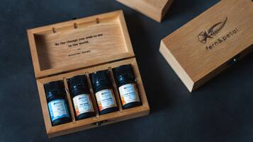 A wooden box with four small bottles of essential oils labeled 'fern&petal'.