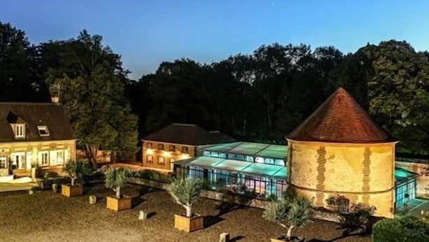 A large, historic building with a prominent tower, surrounded by landscaped gardens and a modern glass structure. - Le Domaine de Montchevreuil (Montchevreuil)