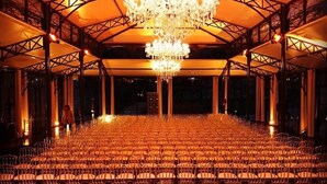An indoor venue with rows of chairs, a large chandelier, and a high ceiling. - Le Domaine de Montchevreuil (Montchevreuil)