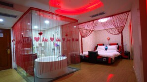 A modern bedroom with a large bed, a bedside table, and a glass-enclosed bathroom with a sink. - BORRMAN Hotel (Guangzhou)