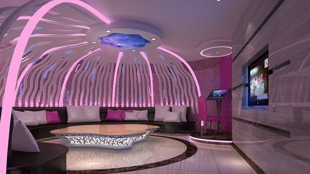 A modern interior with a curved seating area, a ceiling with a starry design, and a digital screen on the wall. - BORRMAN Hotel (Guangzhou)
