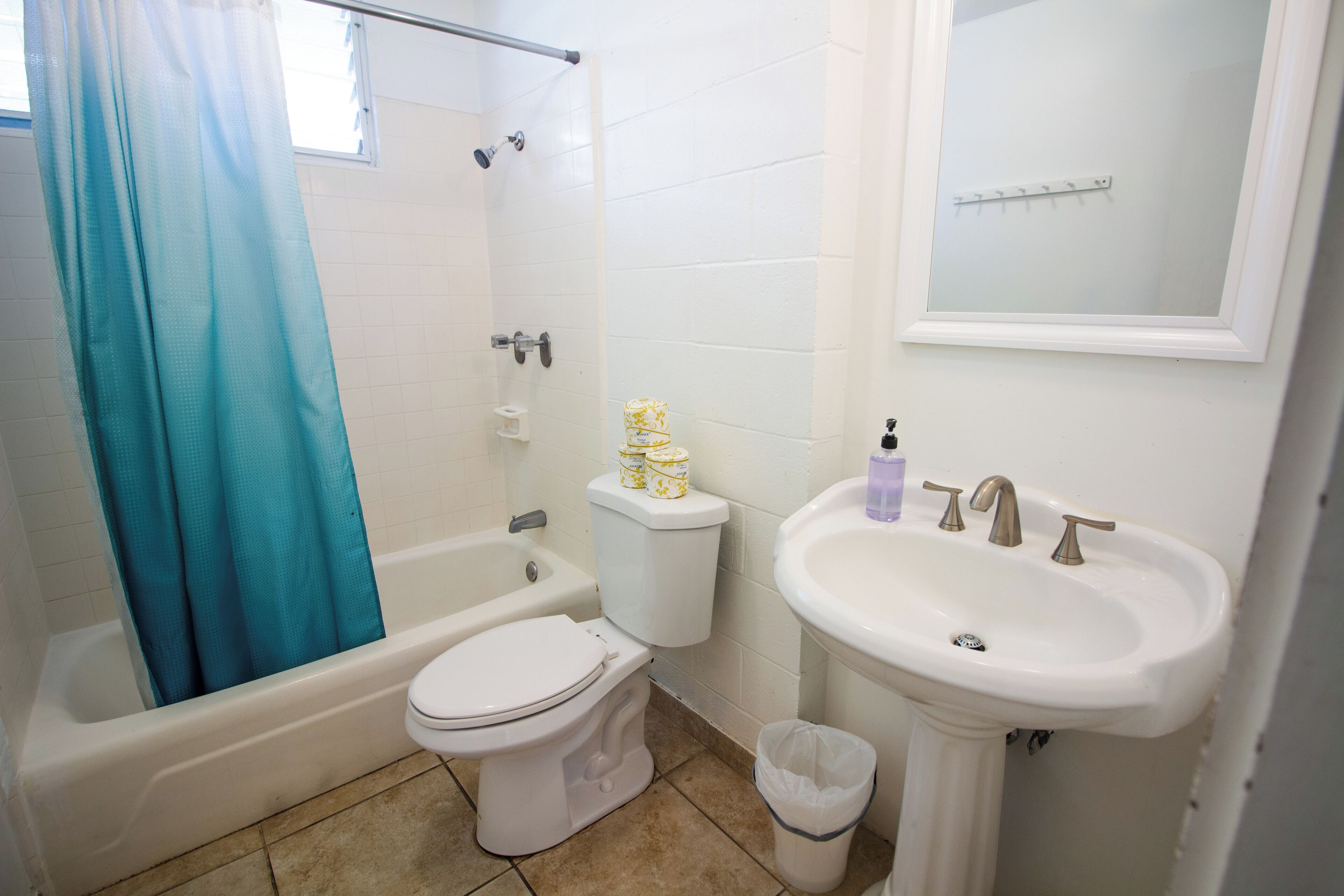A bathroom with a bathtub, toilet, and sink.