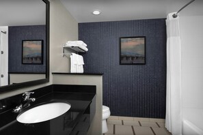 A modern bathroom with a black sink, white toilet, and a shower curtain. - Fairfield Inn & Suites by Marriott Fayetteville North (Fayetteville)