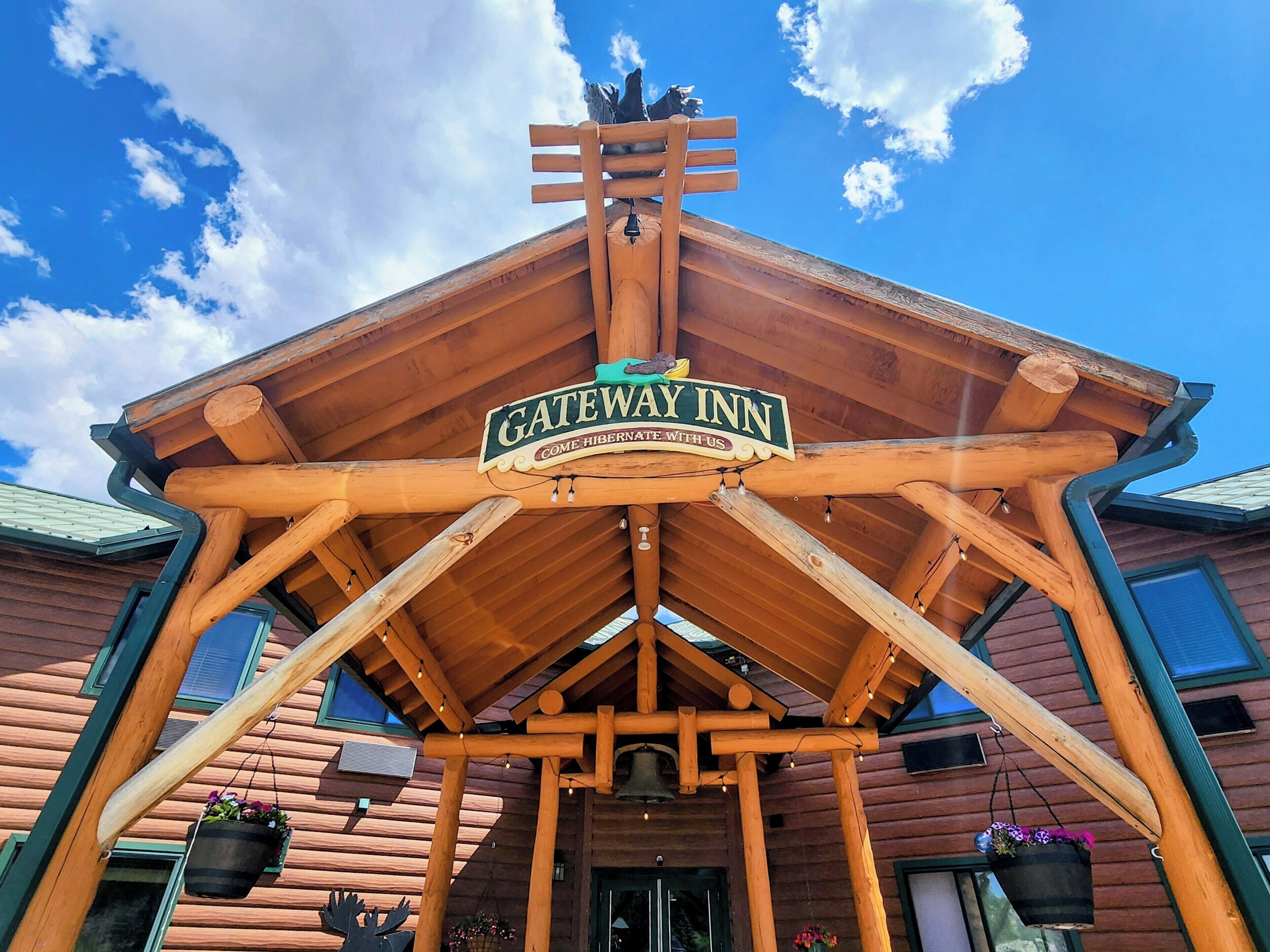 A wooden structure with a sign reading "GATEWAY INN" and a bell.