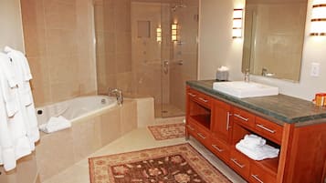 A modern bathroom with a bathtub, shower, and vanity.