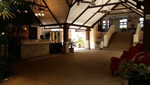 A spacious lobby with a reception desk, potted plants, and a staircase leading to upper floors. - D'Feringghi Haus Hotel & Restaurant (George Town)