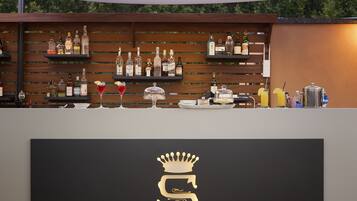 A bar area with shelves of liquor bottles and glasses.