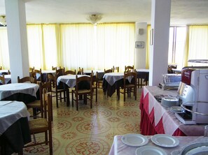 A dining area with tables set for service, chairs, and a coffee machine. - Hotel San Vito (Forio)