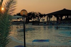 A swimming pool area with lounge chairs and a covered pavilion. - Residence Hotel Riviera Calabra (Zambrone)