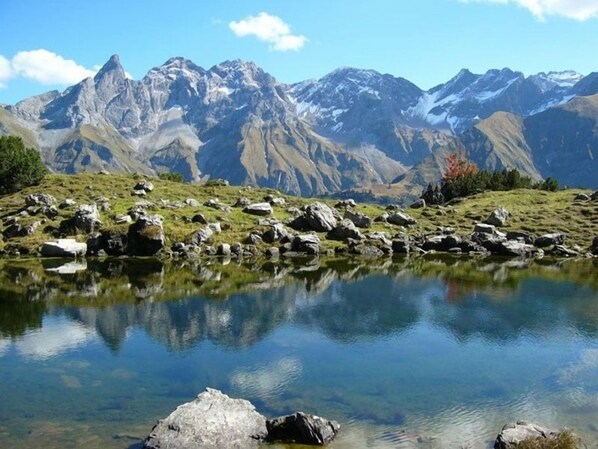 A mountain landscape with a clear lake reflecting the peaks.