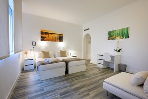 Una camera da letto moderna con un letto matrimoniale, comodini, una scrivania e una sedia.