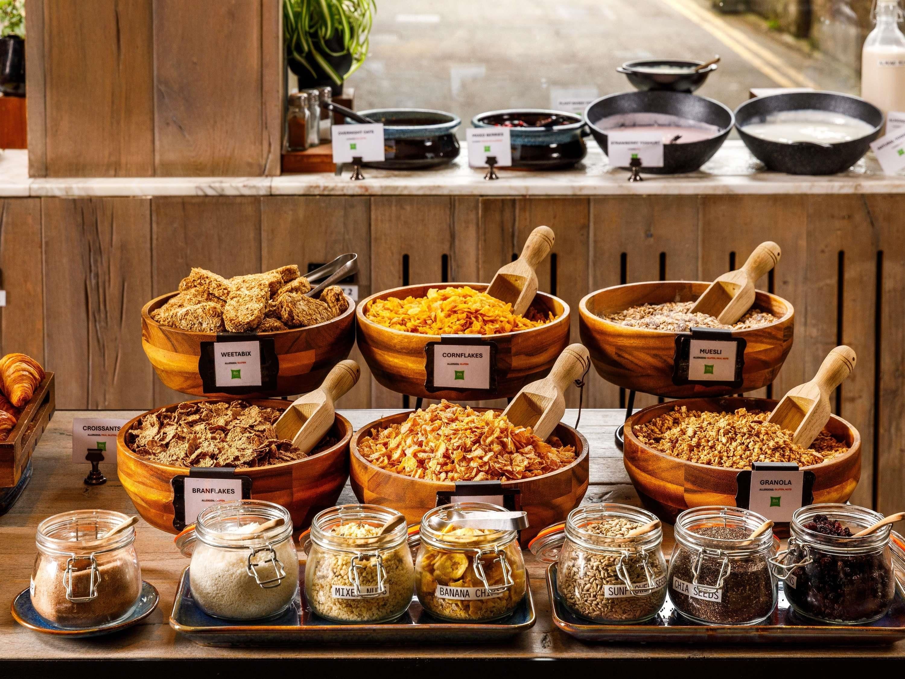 A buffet with various food items and condiments.