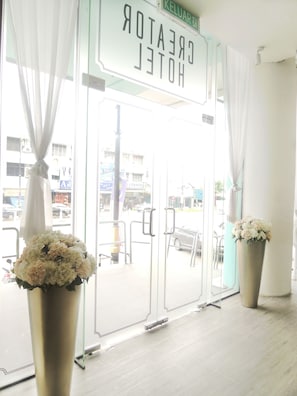A hotel entrance with a sign reading "CREATOR HOTEL" and a view of the street outside. - Creator Hotel (Kulai)