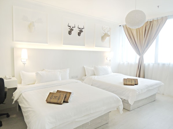 A hotel room with two beds, white bedding, a desk with a chair, and a shower box on each bed. - Creator Hotel (Kulai)