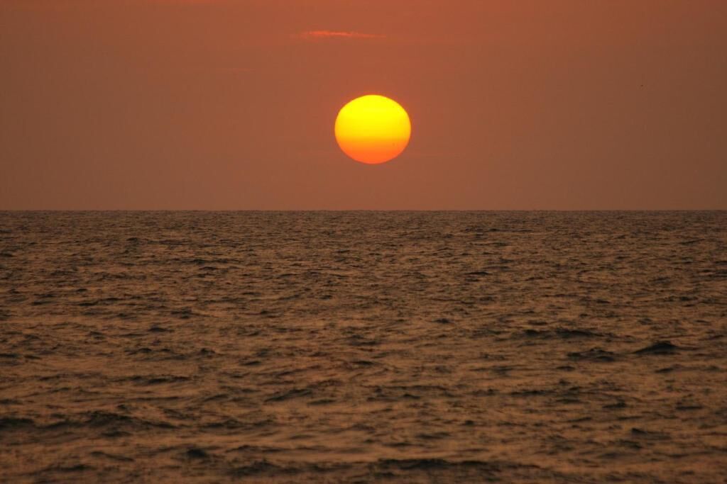 A sunset over a calm sea.