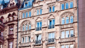 A multi-story building with a classic architectural style, featuring ornate window frames and balconies. - Five Elements Hostel (Frankfurt)