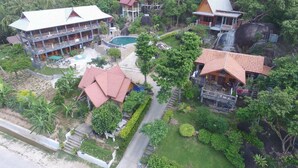 A resort with multiple buildings, a swimming pool, and lush greenery. - Sea Rock Resort (Ko Pha-ngan)