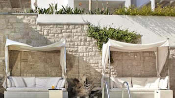 Seasonal outdoor pool, open 11:00 AM to 9:00 PM, pool umbrellas