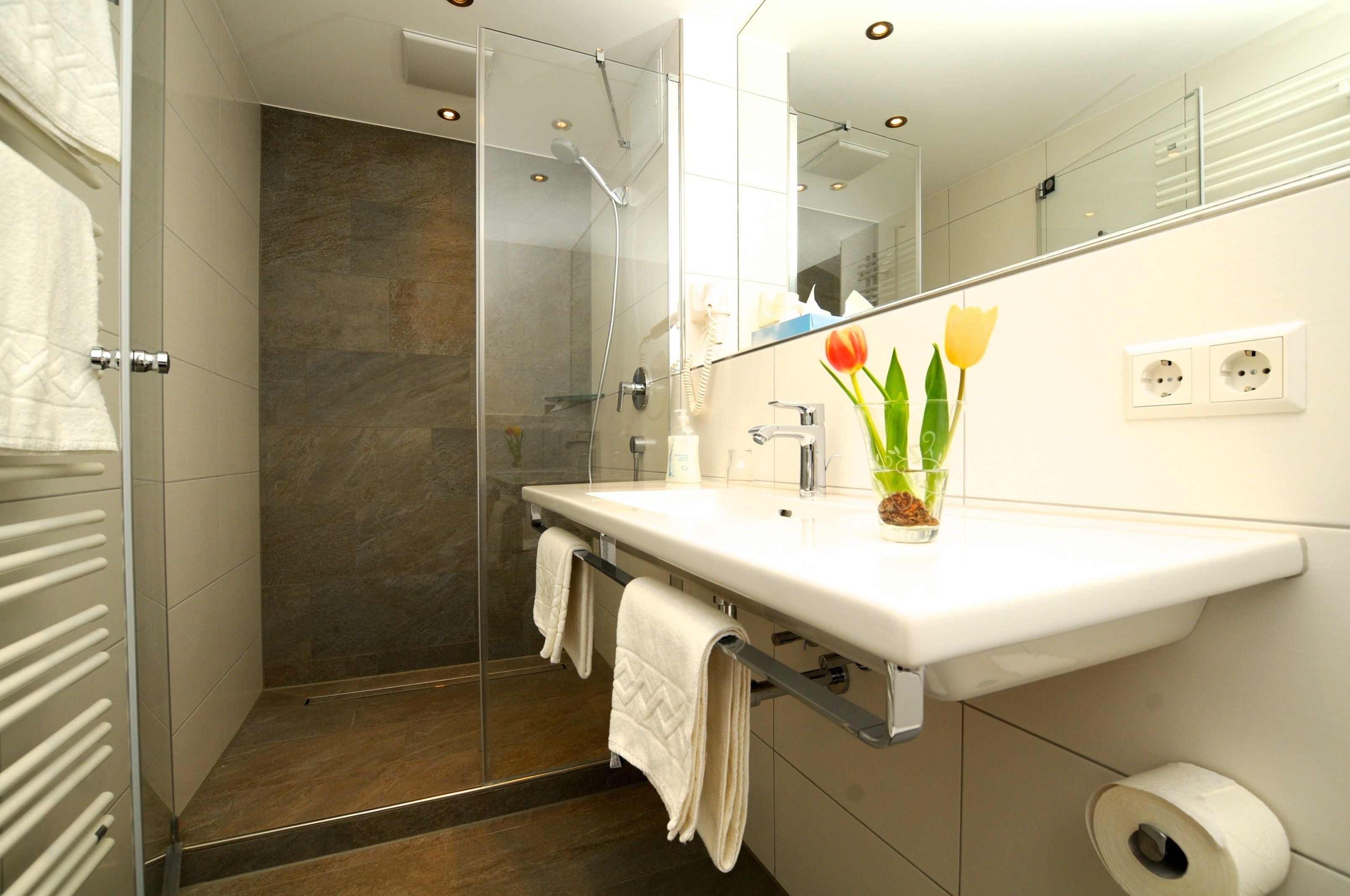 deluxe double room | bathroom | rainfall showerhead, towels