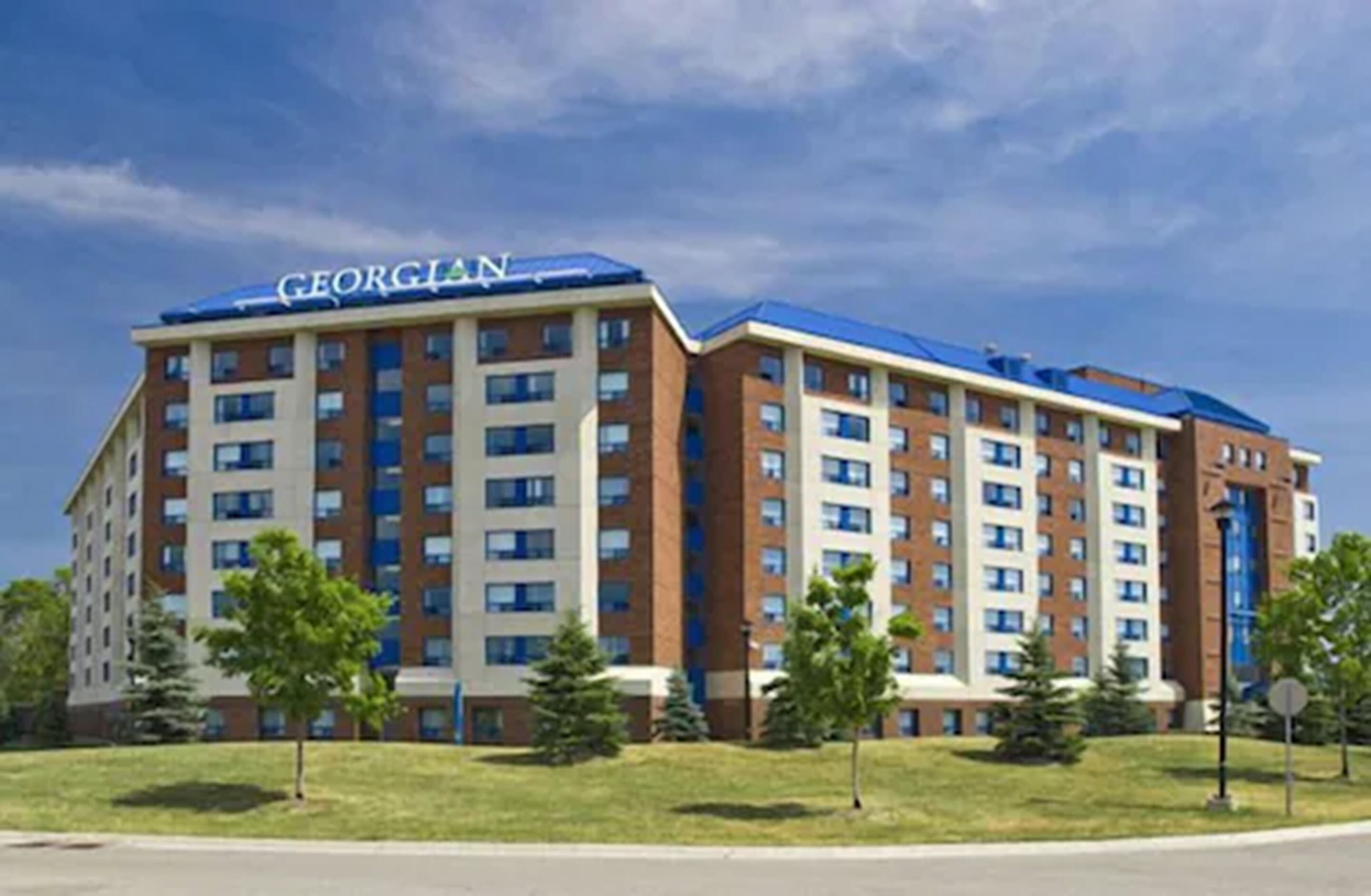 A Georgian hotel with multiple floors, a brick facade, and a blue roof.