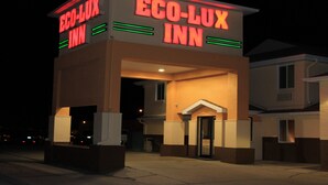 A building with a sign reading "Eco-Lux Inn" at night. - Eco-Lux Inn (Norfolk)