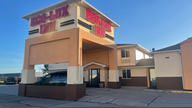 A building with the sign "ECO-LUX INN" indicating a hotel.