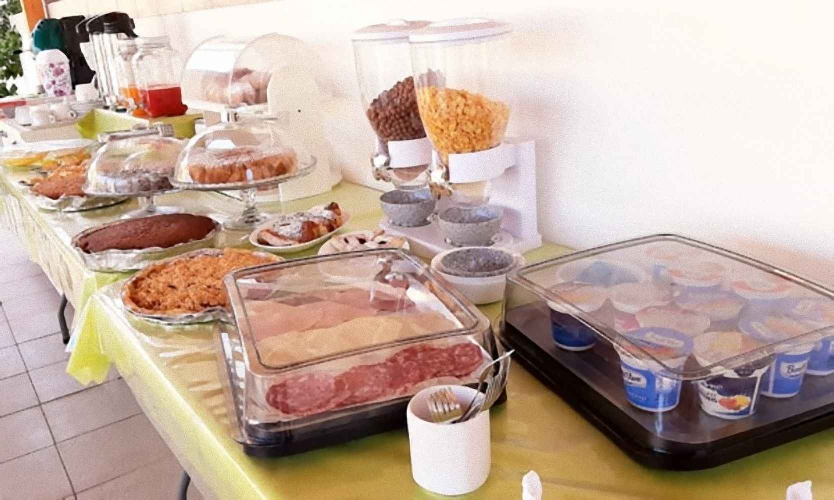 A buffet table with various food items and condiments.