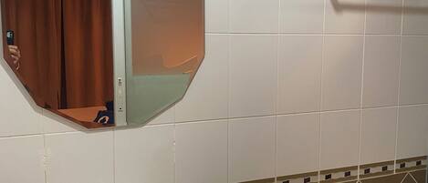 A bathroom with a white sink, a toilet, and a towel rack.