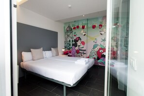 A modern bedroom with a large bed, a glass door, and a colorful mural on the wall.