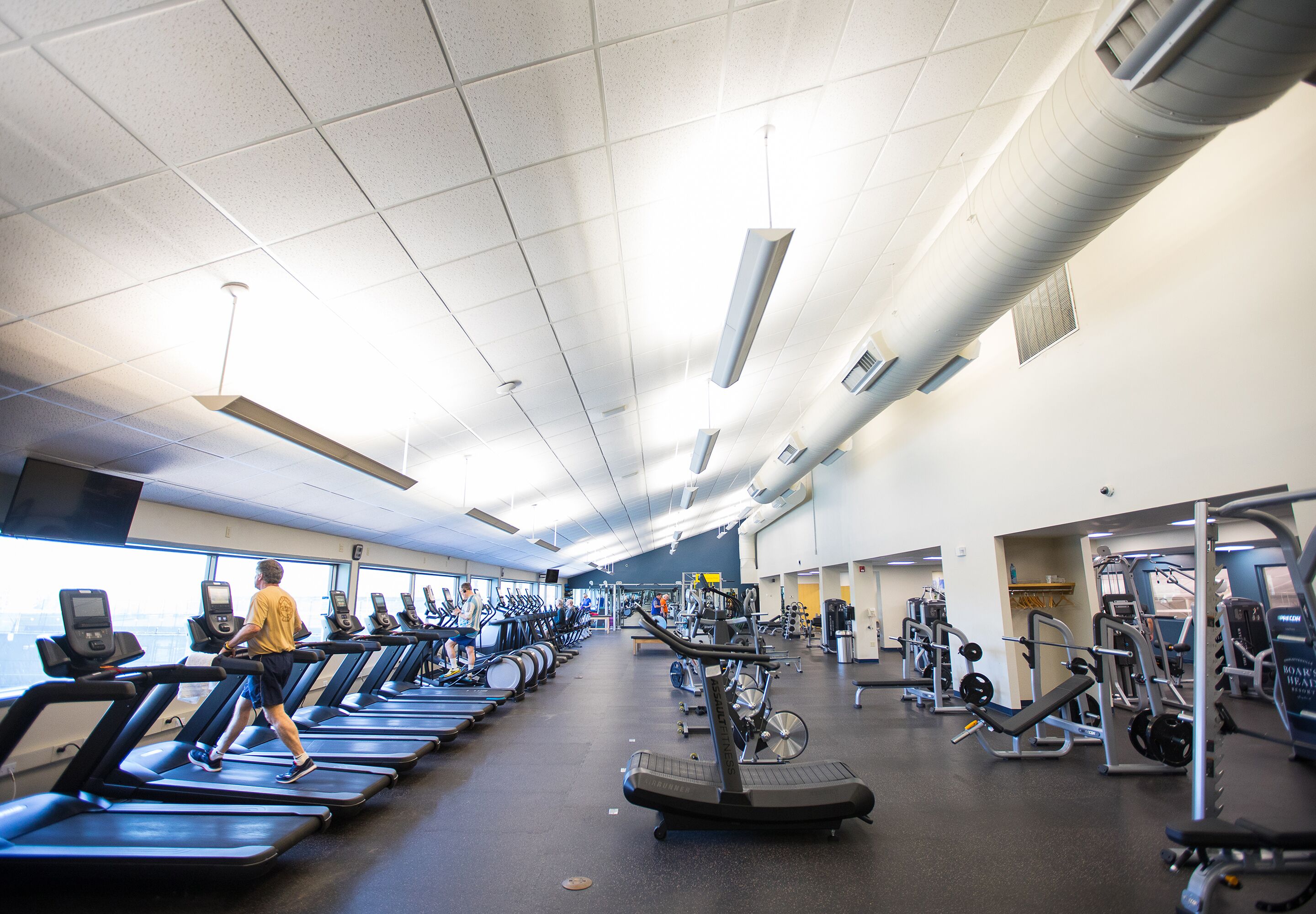 A gym with treadmills, ellipticals, and weight machines.