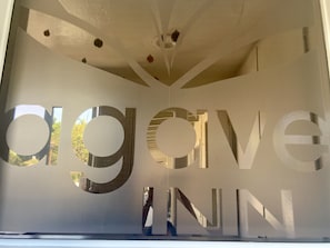 A large, modern interior space with geometric ceiling design and large letters spelling "agov" on the wall.