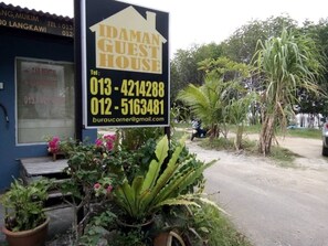 A sign for a guest house with contact numbers and an email address. - Idaman Guesthouse (Langkawi)