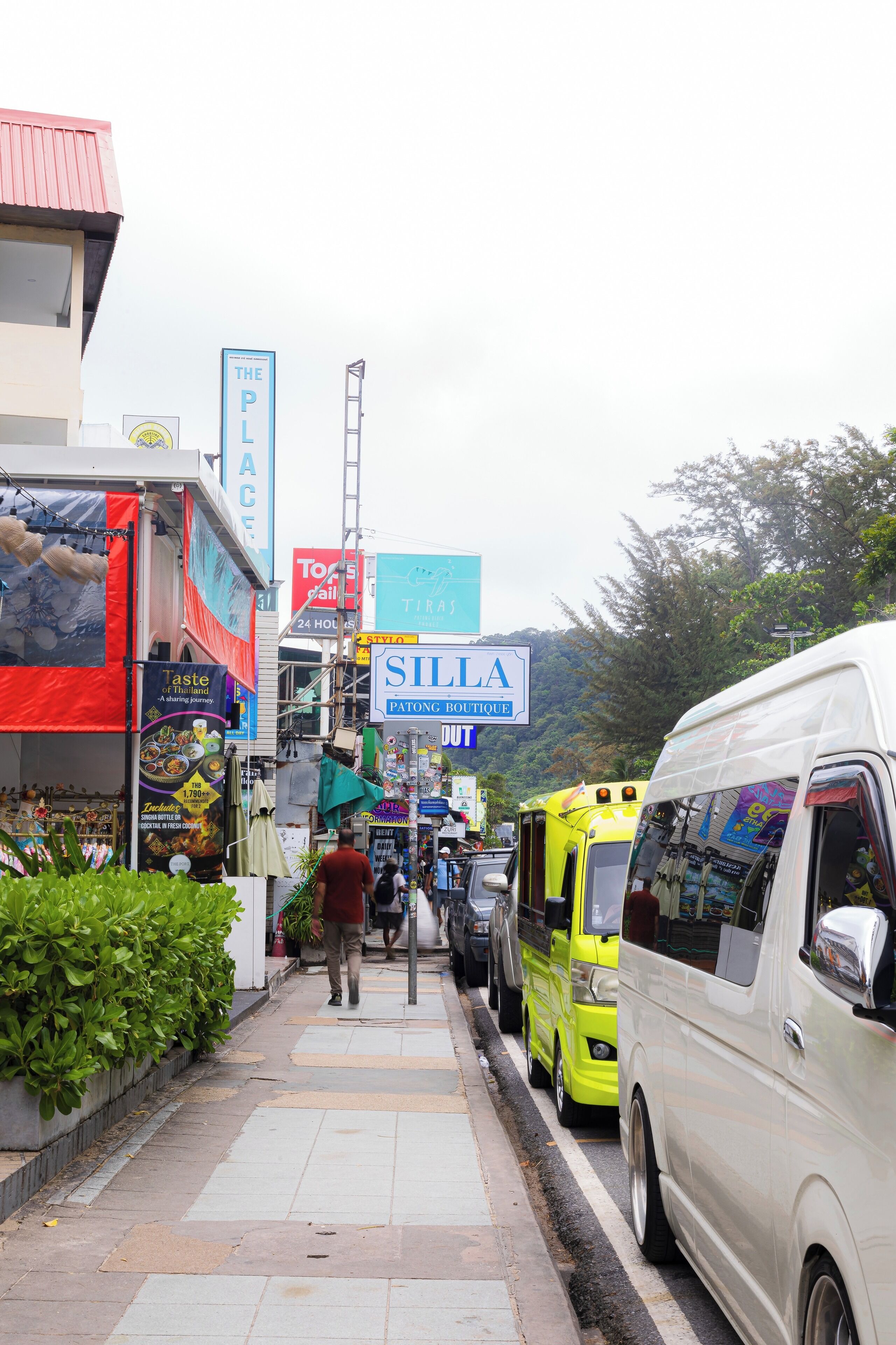 A street scene with various shops, including a visible sign for 'SILLA Patong Boutique'.