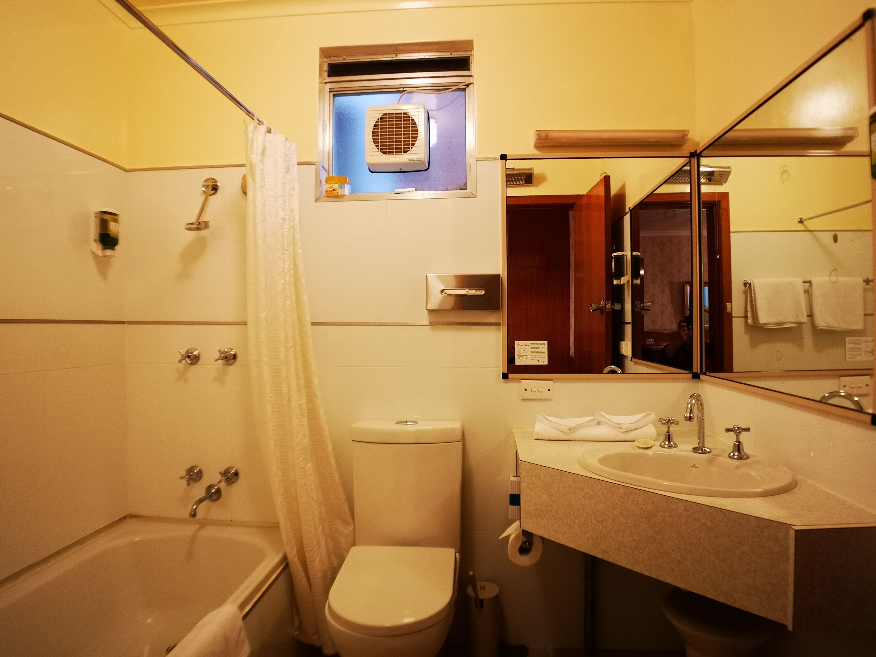 A bathroom with a bathtub, toilet, and sink.