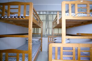 A bunk bed room with two beds, a curtain, and a tiled floor. - H.K Commercial Inn (Kowloon)