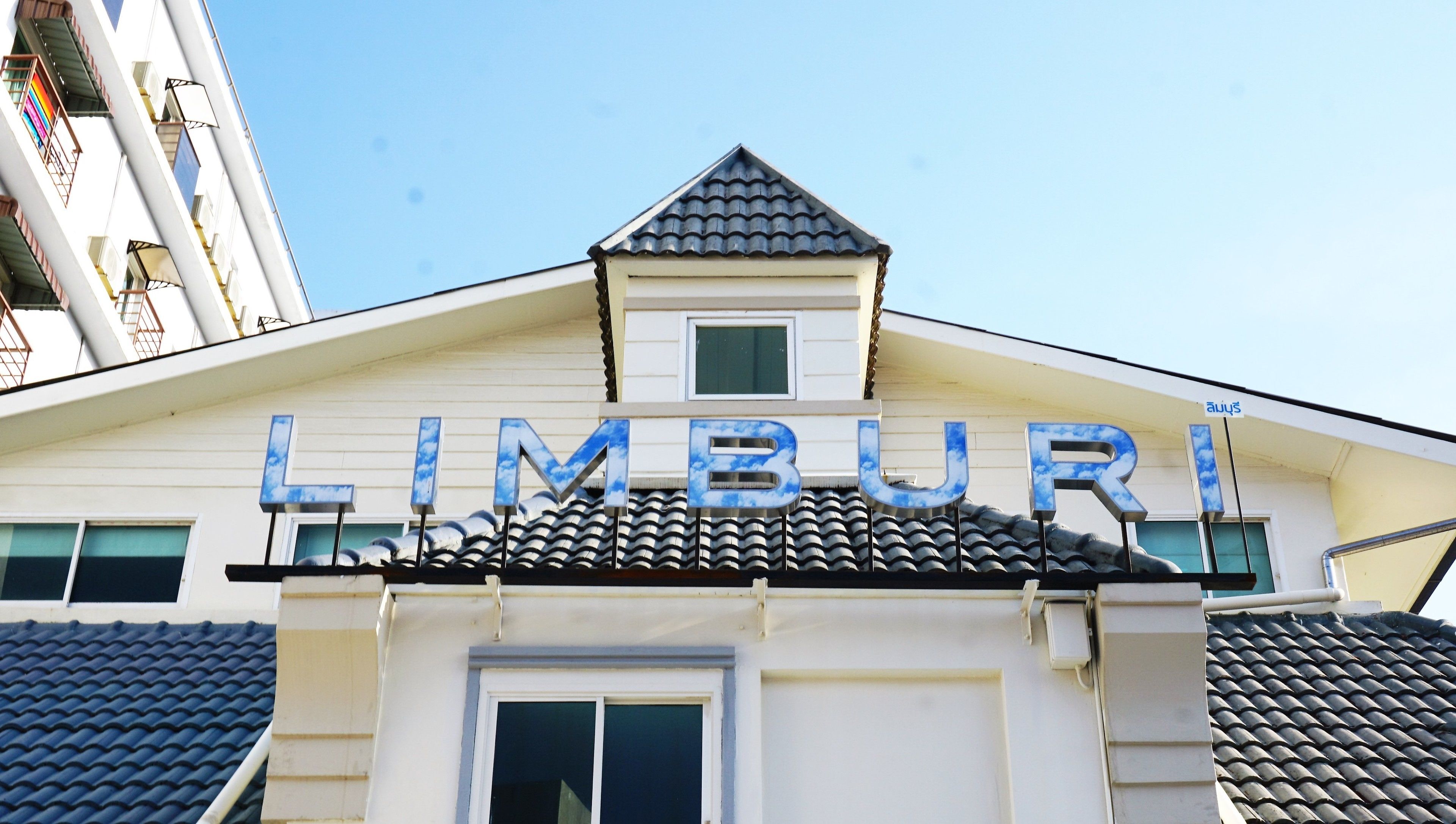 A building with a sign that reads "LIMBURI" in large letters.
