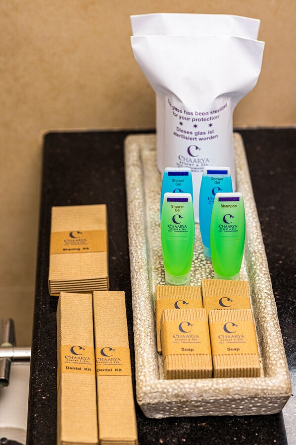 A tray with various toiletries including a dental kit, shampoo, and shower gel.