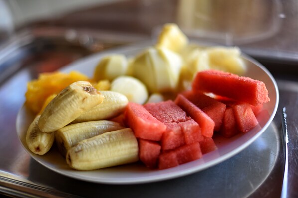 A plate with bananas, watermelon, and other fruits. - Fathala Wildlife Reserve (Fatick)