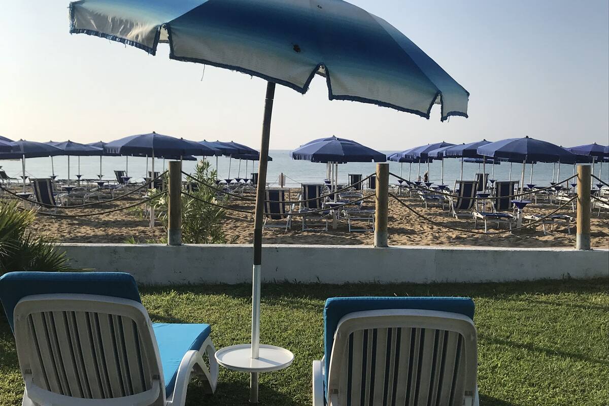 on the beach, sun-loungers, beach umbrellas, beach towels