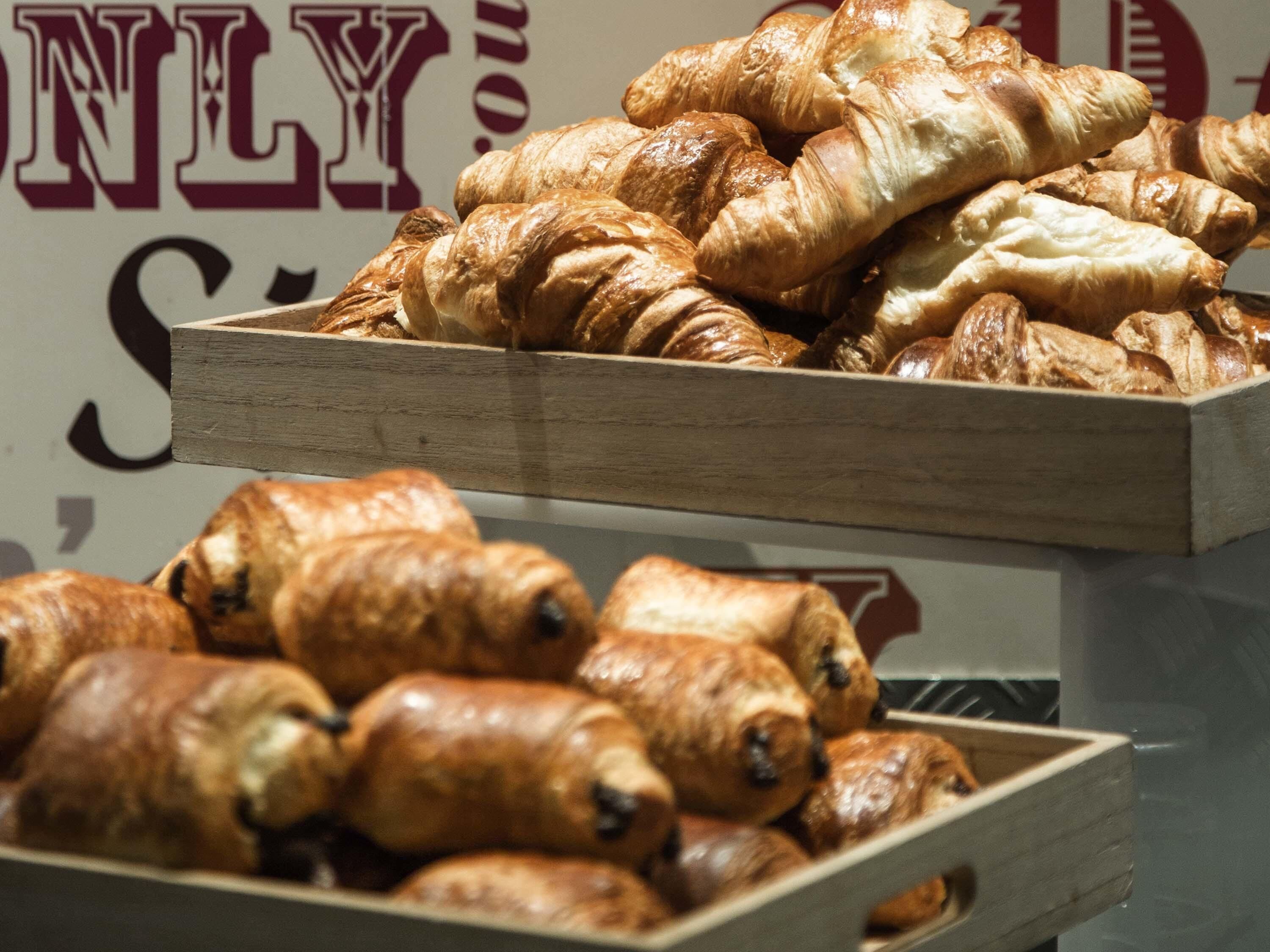 A display of assorted pastries in wooden boxes.