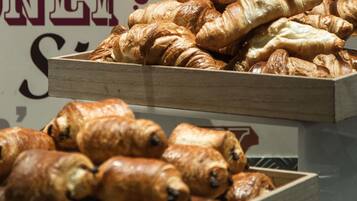 A display of assorted pastries in wooden boxes.