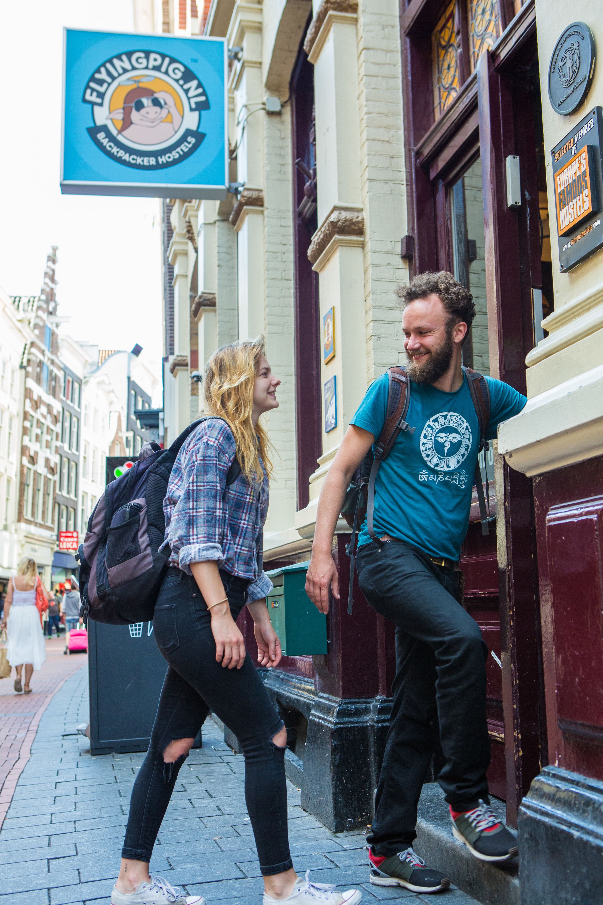 A man and a woman walking on a city sidewalk.