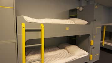 A bunk bed room with numbers 25 and 27 on the walls, indicating room numbers.