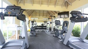 A gym with treadmills, weight machines, and dumbbells. - The Hamilton Beach Villas & Spa (Cotton Ground)