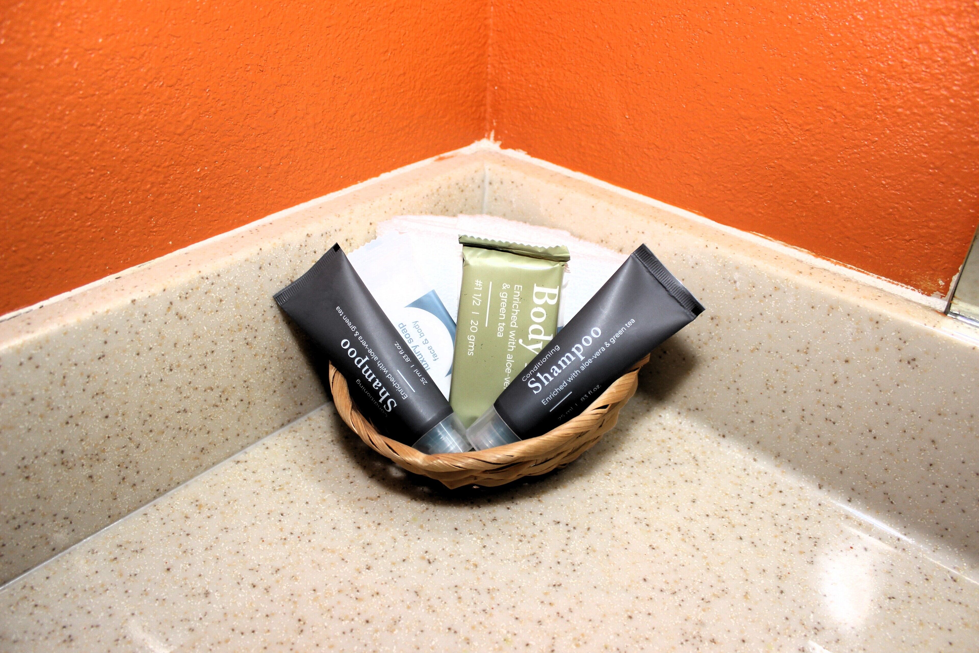 A basket containing toiletries on a countertop.
