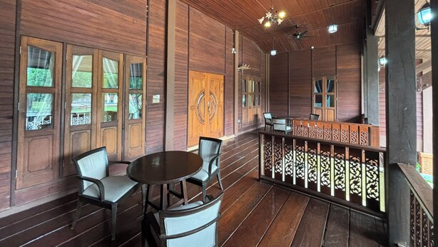A wooden interior with a balcony, ceiling fans, and a table with chairs. - Padimas Villa @Datai Valley (Langkawi)