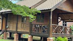 A wooden cabin with a porch, large windows, and a tiled roof. - Padimas Villa @Datai Valley (Langkawi)