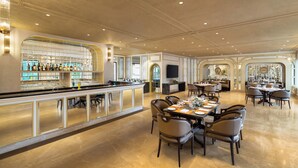 A spacious restaurant with a long bar, multiple dining tables, and a modern interior design. - Fortune Valley View, Manipal - Member ITC Hotels' Group (Udupi)